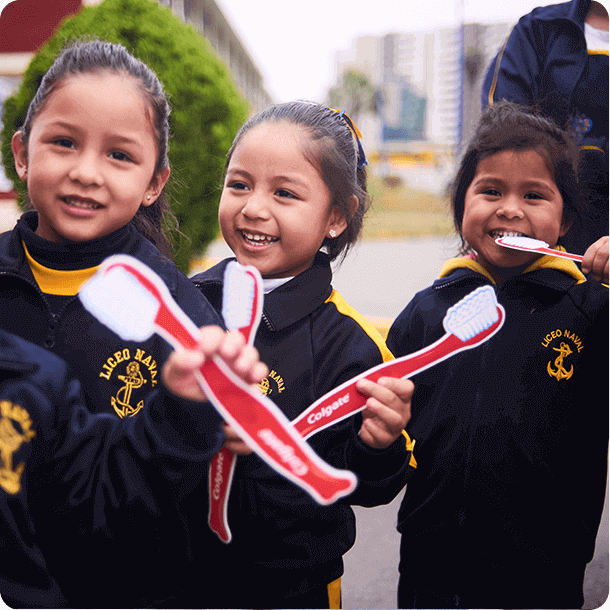 three smiling kids with dummy toothbrushes