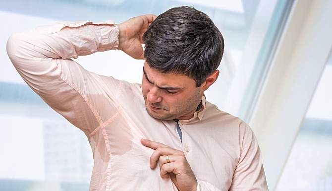 man with a sweat stain in his armpit