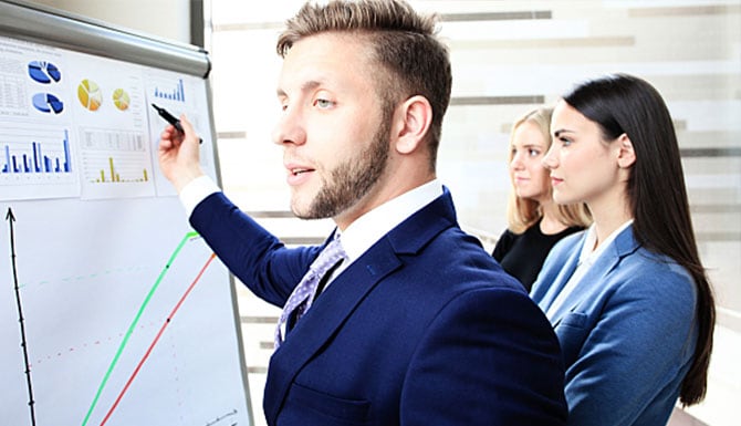 Man showing charts to his team