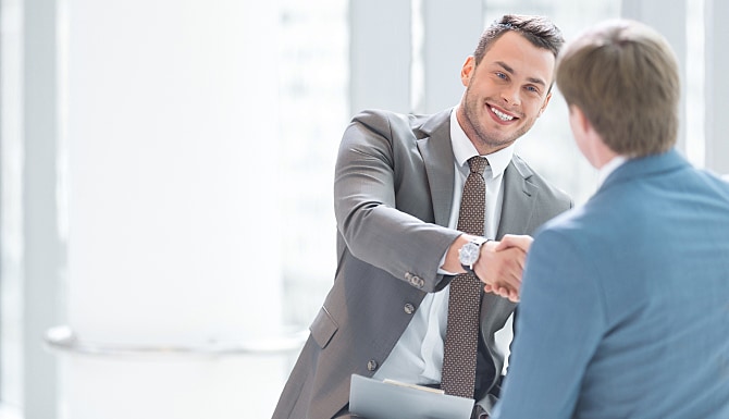 2 men in suits shaking hands