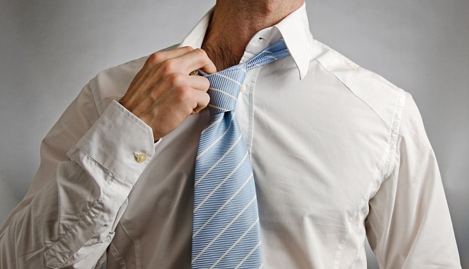 man taking off a tie