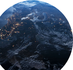 Photo from space of Earth at night, with multiple lights shining brightly through the darkness.