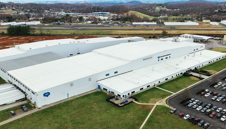 Aerial photo of a Colgate-Palmolive facility within a beautiful landscape representing sustainable practices.