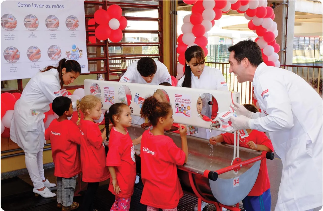 Dentists and oral hygiene experts talking to group of children as part of "Bright Smiles, Bright Futures" event.