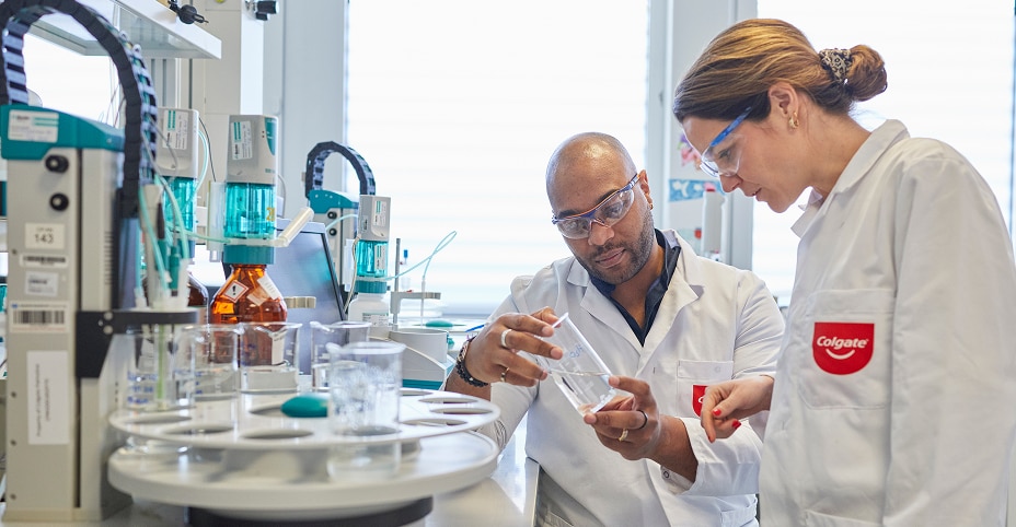 Two Colgate scientists analyzing a sample in a lab during an experiment to develop innovative oral health products.