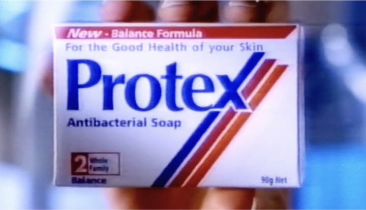 Protex antibacterial soap box from the 1980s with red, blue, and orange stripes, showing product name and label that reads "New - Balance Formula For the Good Health of your Skin".