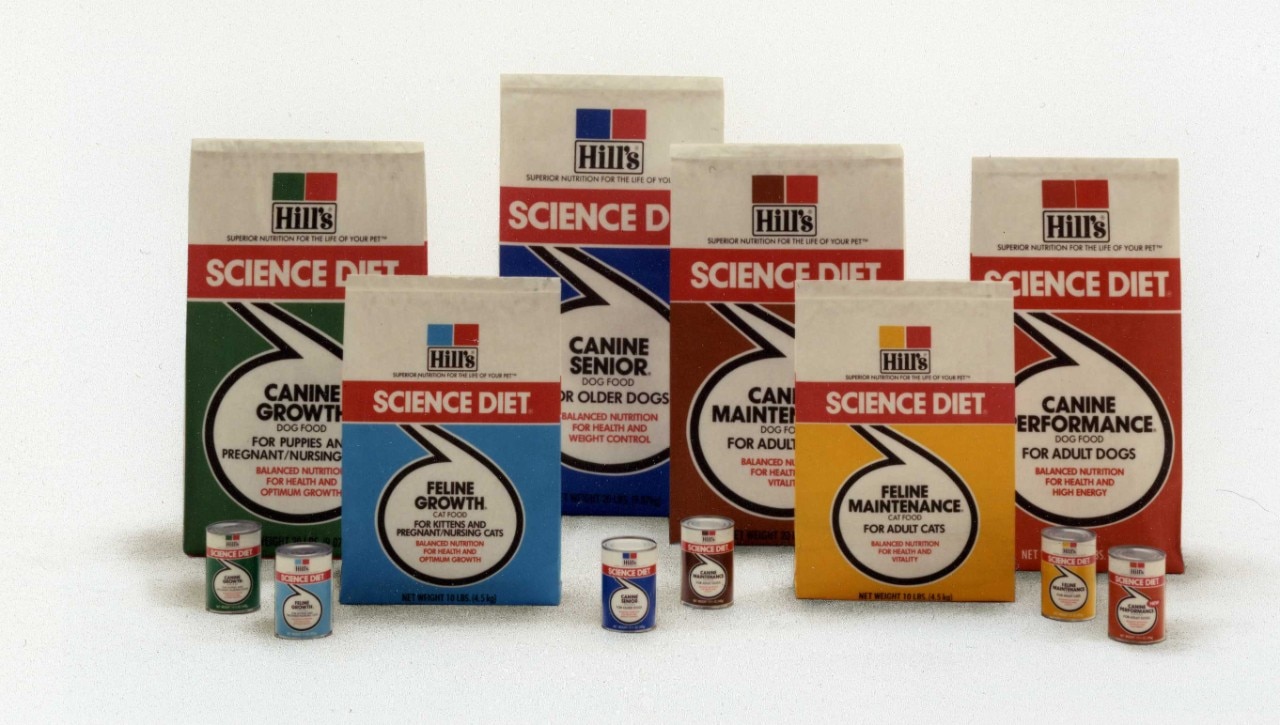 Several Hills Science Diet dog food cans and bags are displayed from the 1970s, including varieties for different health needs and life stages.