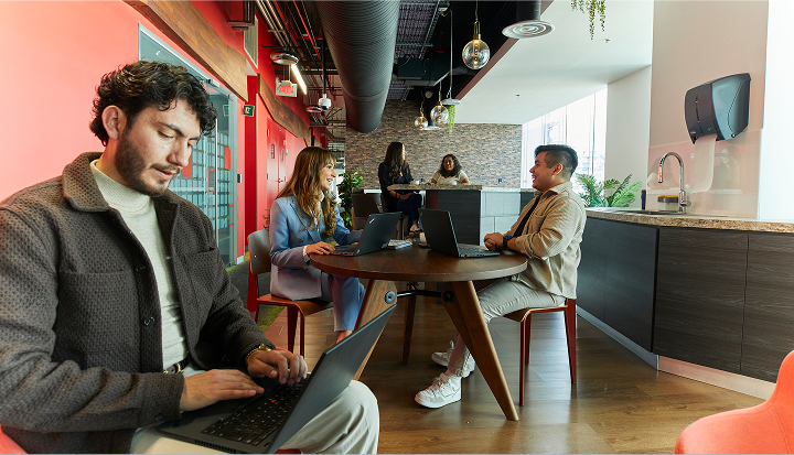 Colgate-Palmolive team collaborating in modern office meeting space.